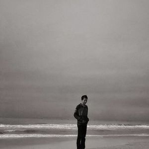 Full length of man standing at beach against sky
