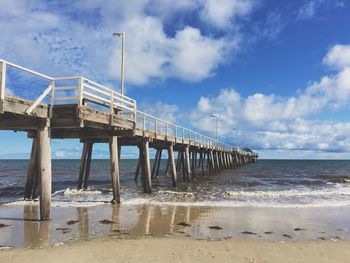 Pier over sea against sky