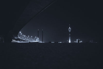 Illuminated city against sky at night