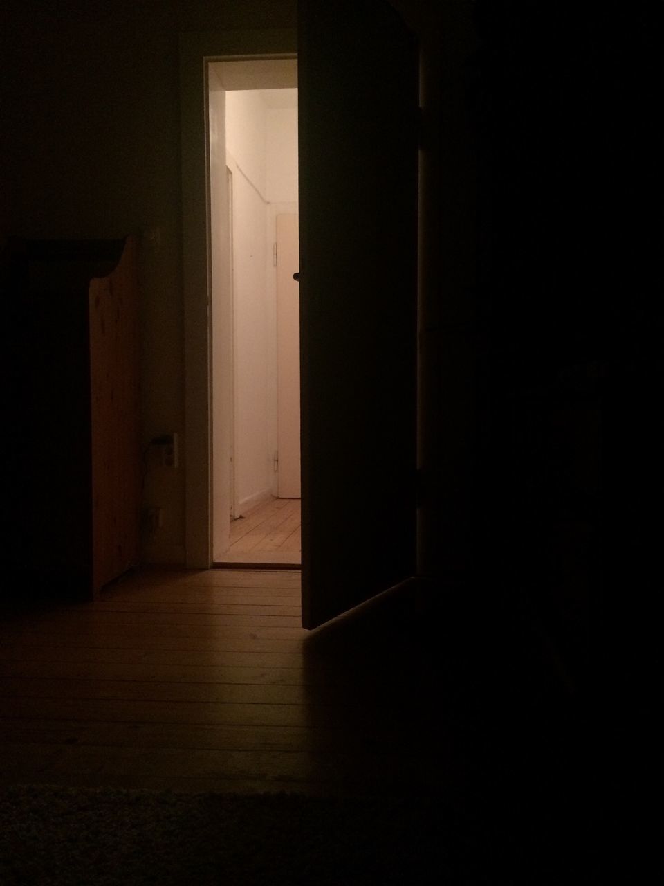 indoors, built structure, architecture, door, dark, window, house, corridor, wall - building feature, empty, illuminated, shadow, flooring, sunlight, entrance, wall, no people, closed, absence, doorway