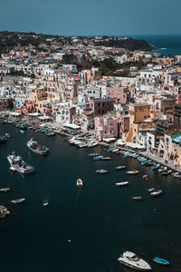 High angle view of townscape by sea against sky