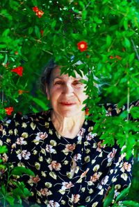 Portrait of senior woman by plants