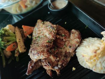 High angle view of meat on barbecue grill