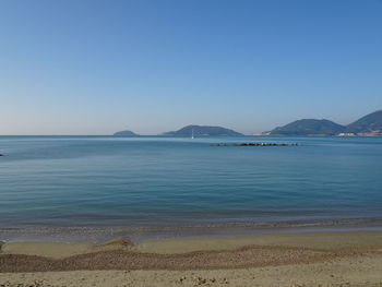 Scenic view of sea against clear blue sky