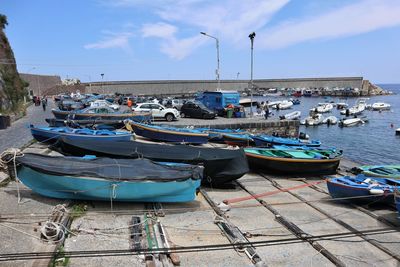 Boats moored at harbor in city