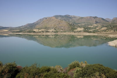 Scenic view of lake and mountains against clear sky