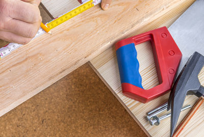 Cropped image of carpenter marking on wood while working