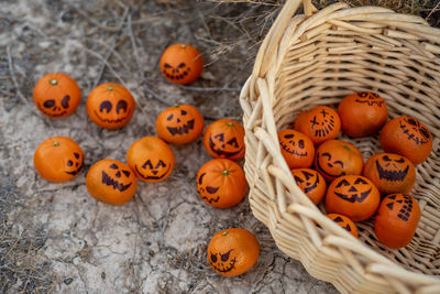 Healthy trick or treat snacks for kids on halloween--basket of mandarin oranges jack o lantern faces