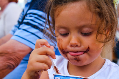 Close-up of cute girl eating chocolate