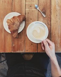 Midsection of man having breakfast on table