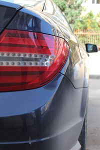 Close-up of red car on street