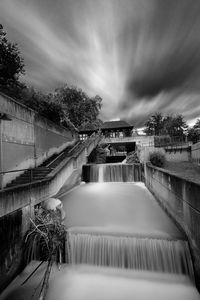 Scenic view of waterfall against sky