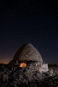 Rock formations against sky at night