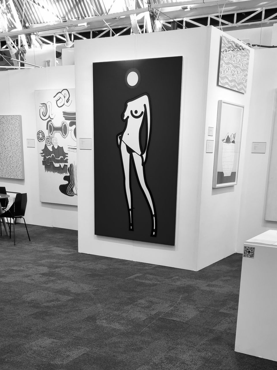 white, black, indoors, black and white, exhibition, monochrome, monochrome photography, person, art, drawing, human representation, creativity, representation