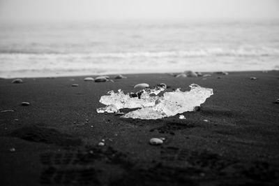 Surface level of sand on beach against sea