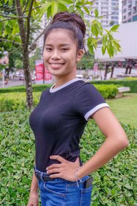 Portrait of teenage girl standing on field