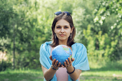 Portrait of woman holding globe