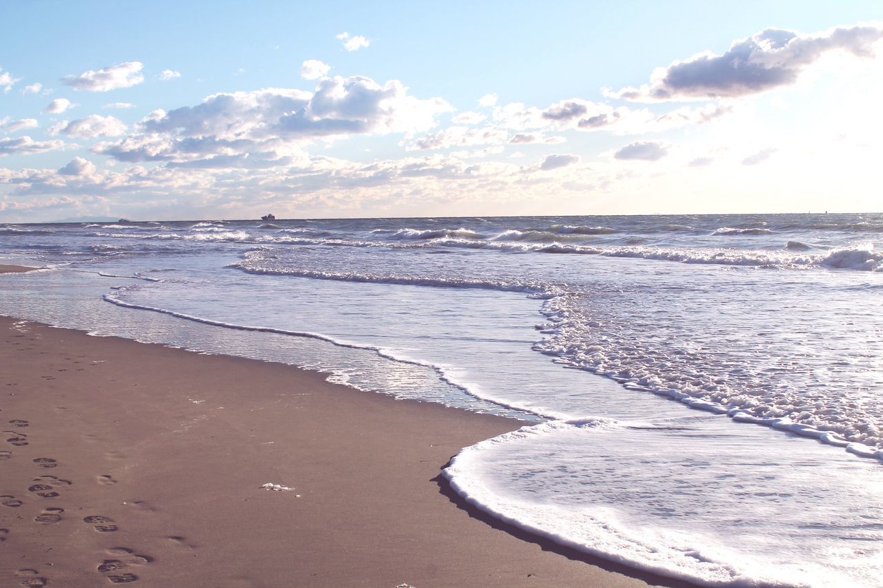 sea, beach, horizon over water, water, shore, sky, sand, tranquil scene, tranquility, scenics, beauty in nature, wave, nature, cloud - sky, idyllic, surf, coastline, cloud, outdoors, remote