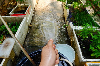 Cropped image of hand holding water fountain