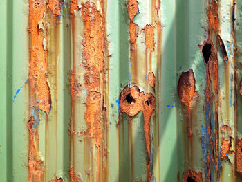 Full frame shot of peeled off rusty corrugated iron
