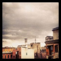 Low angle view of building against cloudy sky