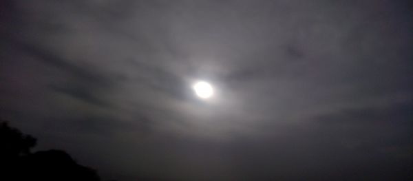 Low angle view of moon in sky at night