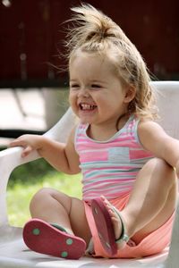 Portrait of a smiling girl sitting outdoors