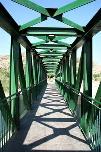 Empty footbridge along railings