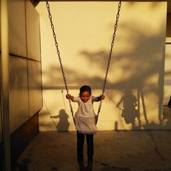 Girl swinging in playground