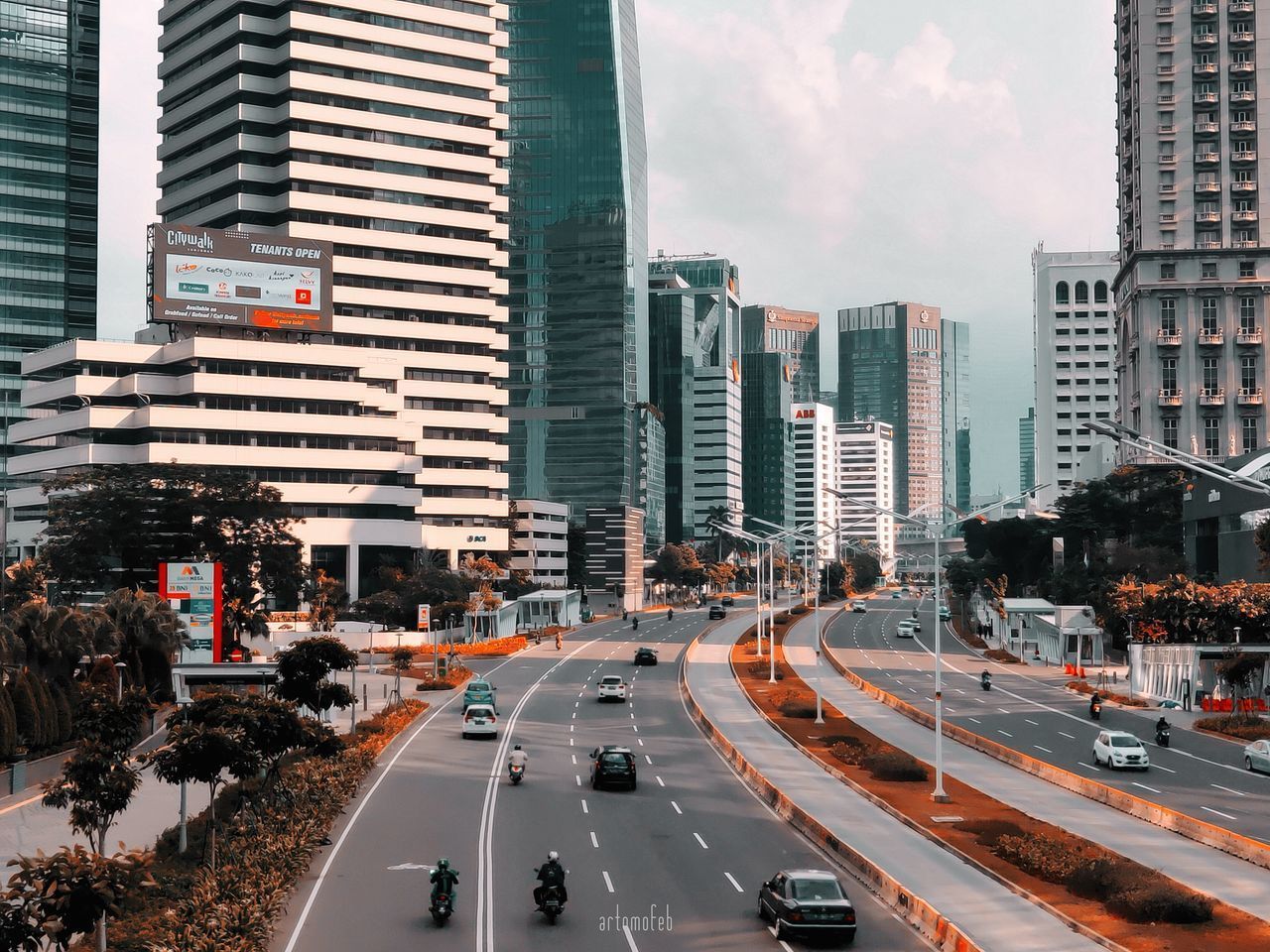 TRAFFIC ON ROAD IN CITY AGAINST SKY