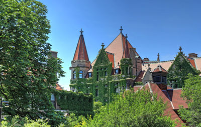 Low angle view of buildings against clear blue sky