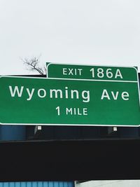 Low angle view of information sign against clear sky