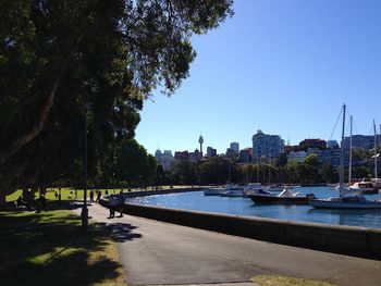 Scenic view of river by buildings against clear sky