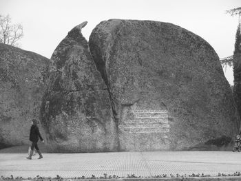 Full length of woman standing on rock