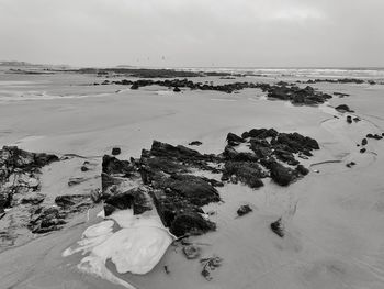 View of rocks on beach against sky