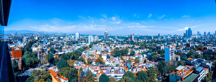 High angle view of modern buildings in city against sky