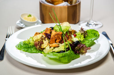 Fresh leaf salad with forest mushrooms with berries and truffle oil dressing