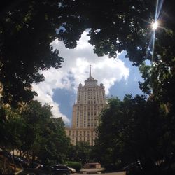 Low angle view of buildings against cloudy sky