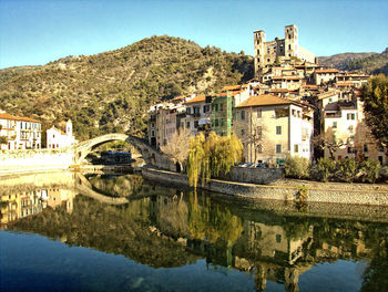 Reflection of buildings in lake against sky