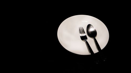 Close-up of electric lamp over black background