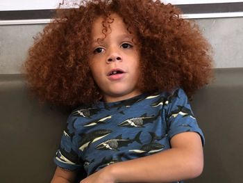 Boy with curly hair looking away