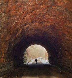 Person standing in tunnel