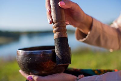 Close-up of woman holding rin gong outdoors