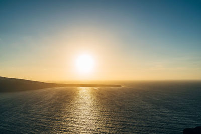 Scenic view of sea against clear sky during sunset