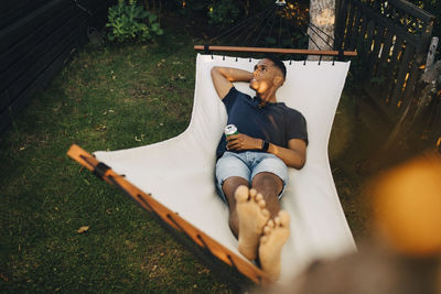 Man lying down while sitting on land