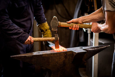 Close-up of two blacksmiths working