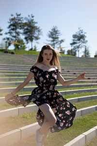 Portrait of young smiling woman at park