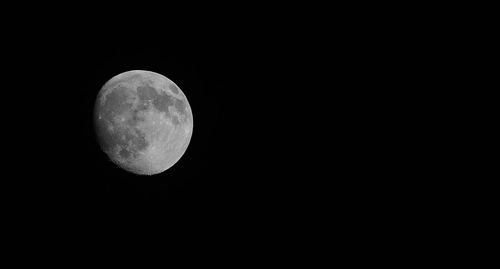 Low angle view of moon against clear sky at night