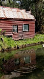 Old house by lake against building