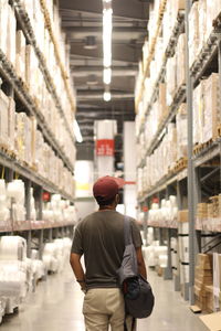 Rear view of man standing at warehouse